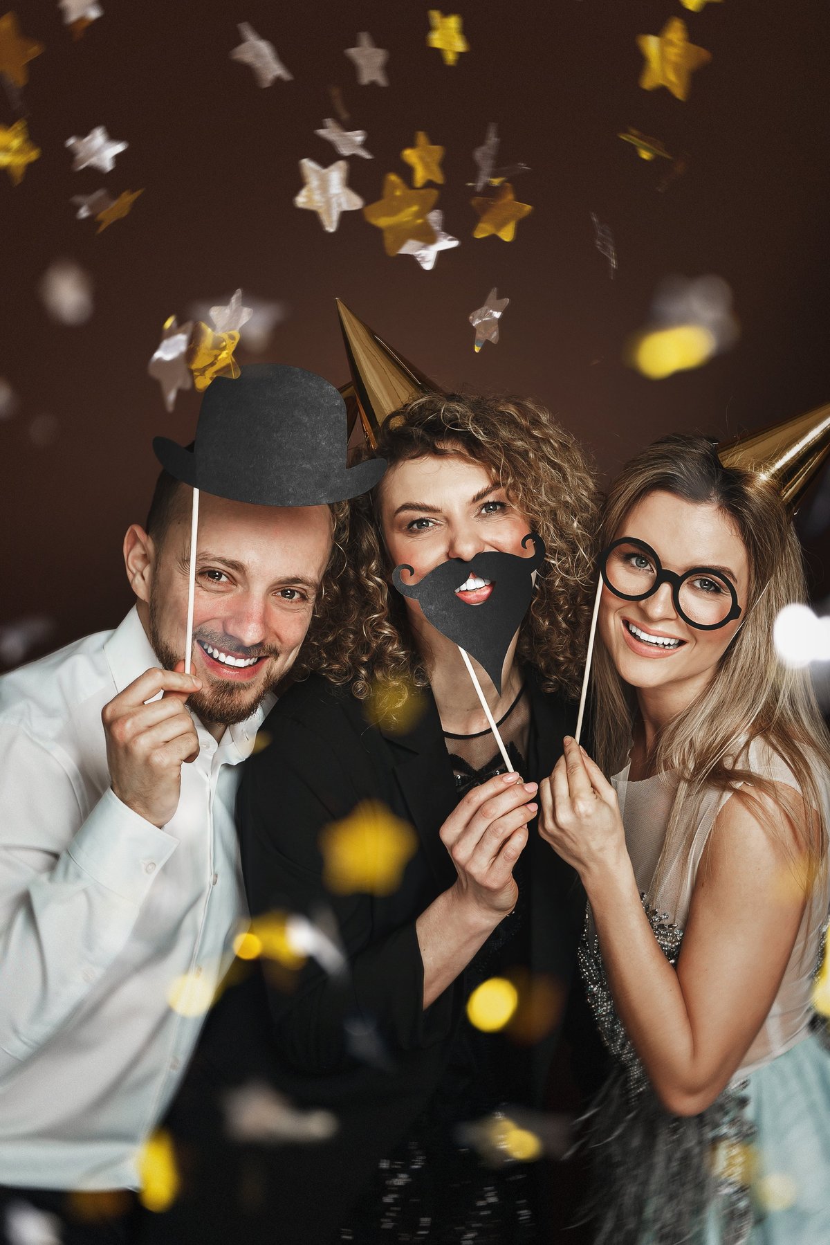 Happy group of people using fun photo booth props